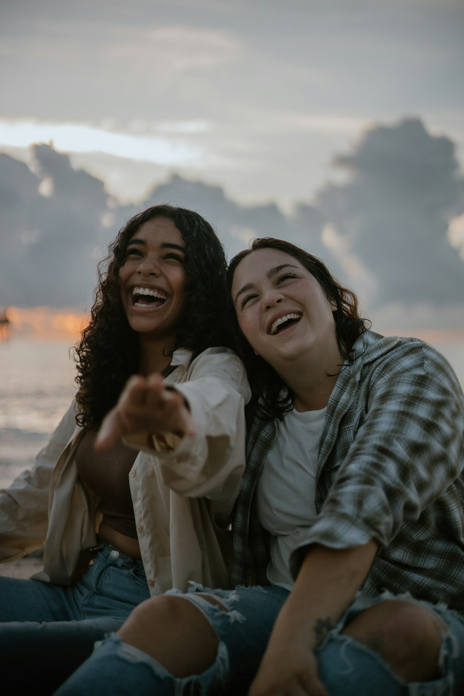 Two friends laughing on the beach